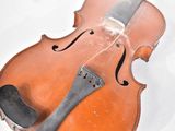 a violin that is sitting on a white surface