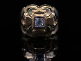 an image of a gold ring with a blue diamond