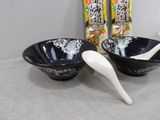 two bowls and a spoon sitting on a table