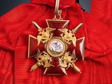 an image of a red jacket with a gold medal on it