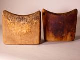 two pieces of wood are sitting next to each other on a table