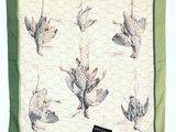 a green and white scarf with birds on it