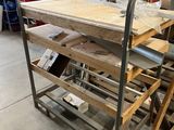 a wooden table on a metal cart in a warehouse