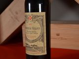 a bottle of wine sitting on a table next to a wooden box