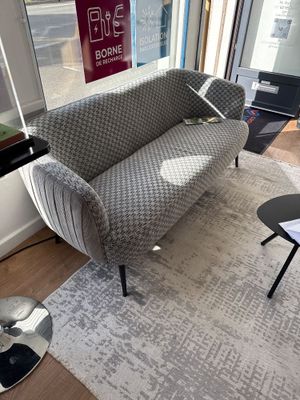 a couch that is sitting on a rug in a living room