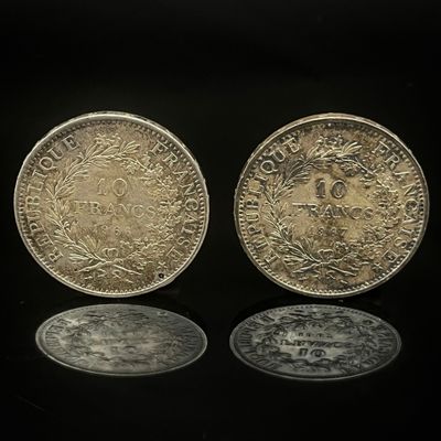 deux pièces d'argent posées l'une à côté de l'autre sur une surface noire