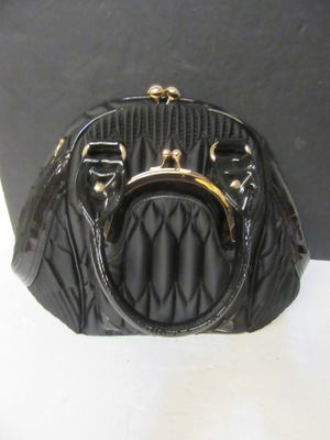 a black purse that is sitting on a table