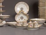 many plates and bowls that are sitting on a table