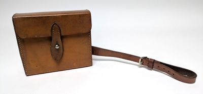 brown leather case with a strap on a white background