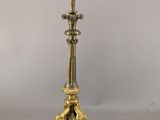 an antique brass candlestick with a candle holder on top of it