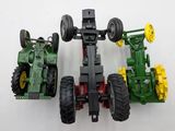 a toy tractor and a toy tractor on a white surface