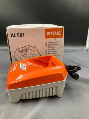an orange and white electric blower sitting on top of a table