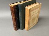 three books sitting on top of each other on a gray surface