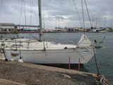 a white sailboat that is docked in the water