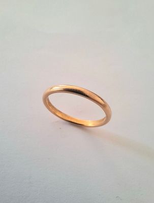 a close up of a gold ring on a white surface