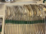 a lot of silver spoons and spoons in a box