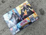 two anime dvds sitting on the ground next to each other