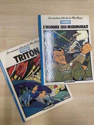 two comics are sitting on a table next to each other