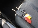 a car seat with a bunch of keys attached to the back of it