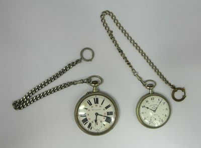 two clocks that are sitting next to each other on a table
