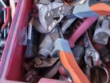 many different tools in a red box on the table