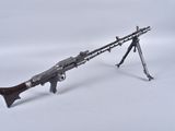 an old machine gun on a tripod stand on a white background