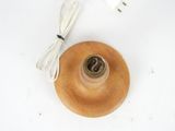 a small wooden object with a cord attached to it