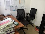 an office with a desk, chair, and a fire place