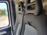 a seat in the back of a van with a window open