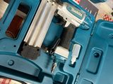 a blue box with a stapler and a stapler in it