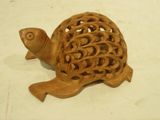 a wooden turtle that is sitting on a table