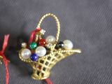 a small basket with pearls and a bell hanging from it