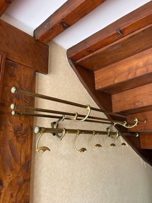 a wooden staircase with a bunch of hooks on it