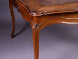 an old wooden table with a wooden top on a grey background