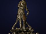 a bronze statue of a man standing on top of a rock