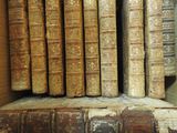 many old books sitting on a shelf in a box