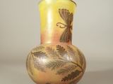 a vase with a design on it sitting on a table