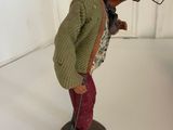 a figurine of a man with a hat and a cane