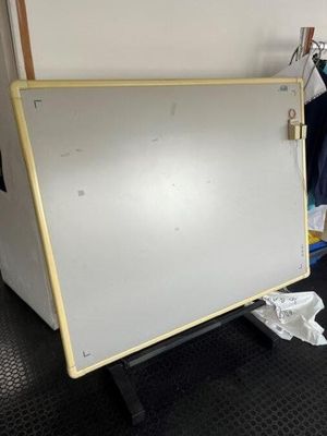a dry eraser on a cart in a room