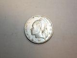 a silver coin with a picture of a man ' s head on it