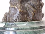 a statue of a man sitting on top of a marble base