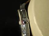 a close up of a watch on a black surface