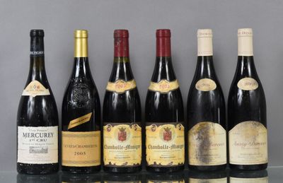 several bottles of wine are lined up in a row on a table