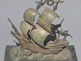 a statue of a ship that is sitting on top of a base