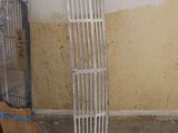 a radiator next to a window and a fan in a room