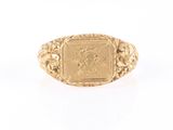 a close up of a gold ring with a picture on it