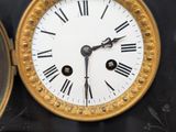 a black and gold clock with roman numerals on it