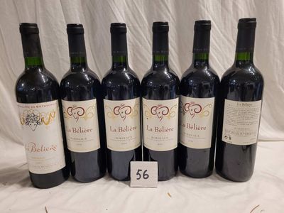 six bottles of wine are lined up in a row on a table