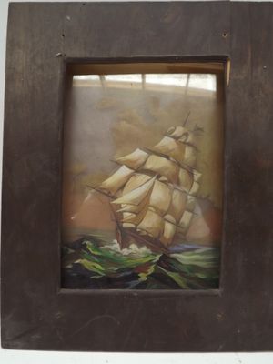 painting of a sailing ship in a wooden frame on a wall