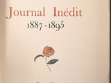 a book with a rose on it sitting on a table